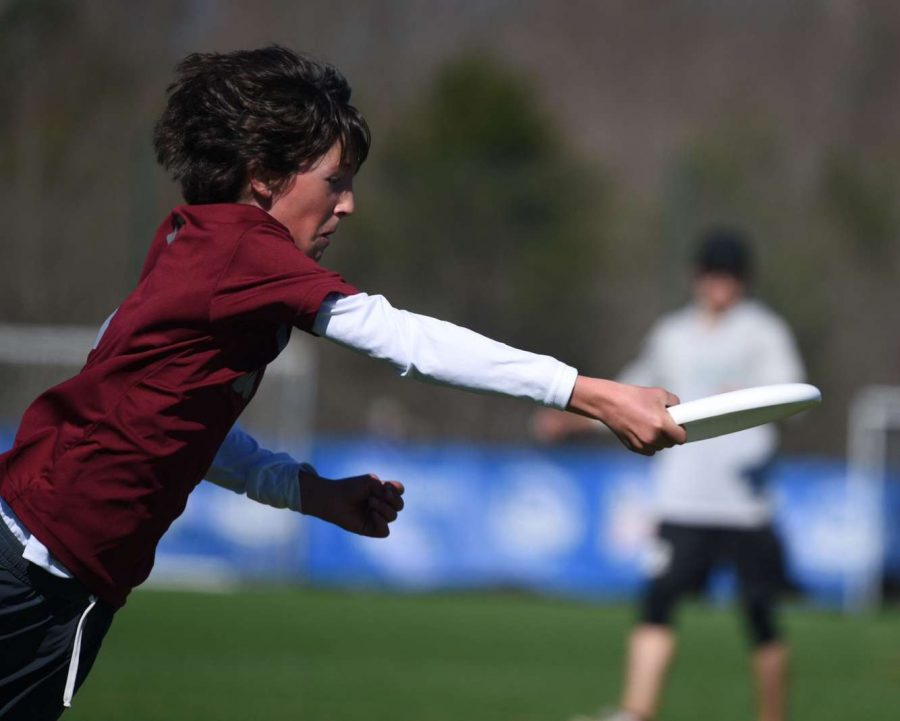 Junior cross country runner and ultimate frisbee player Sam Rose dives through the air to catch the disc at the 2019 Queen City Tune Up Youth Tournament in Charlotte, N.C.