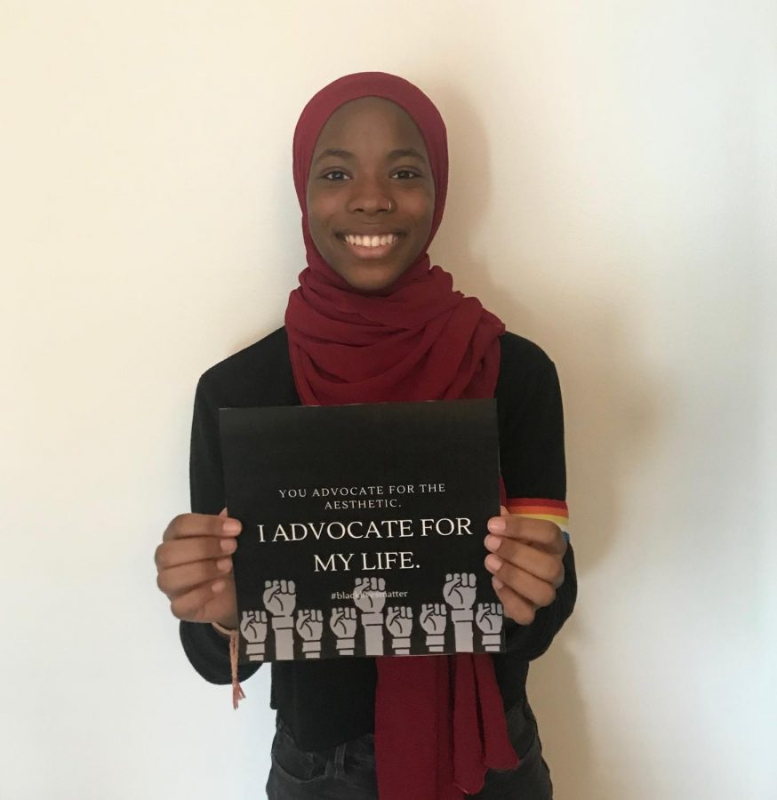 Senior Inaya Abdul-Haqq showcases her print, which features the phrase, You Advocate for the Aesthetic, I Advocate for My Life. This design and others can be found on merchandise that she sells on Redbubble. Abdul-Haqq gives the revenue from the sales to Atlanta Solidarity Fund.
