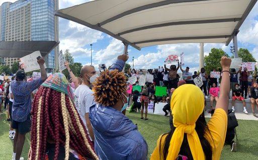 Protesters at the Justice for Us march on March 29 gather together in downtown Atlanta. Some participants raise their fists to show solidarity.