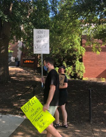 Grady alumni Patrick Busko and  Sarah Shanahan complete a lap  around Grady High School to show their support for the movement to rename the school. 