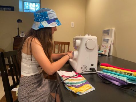 Junior Annie Robinson works on her colorful custom masks. She had the idea to sew masks to help slow the pandemic, make money and fill up her time.