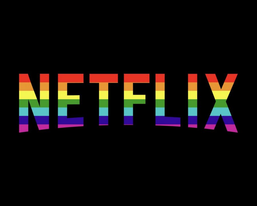 The Netflix logo in the colors of the LGBTQ pride flag against a black background.