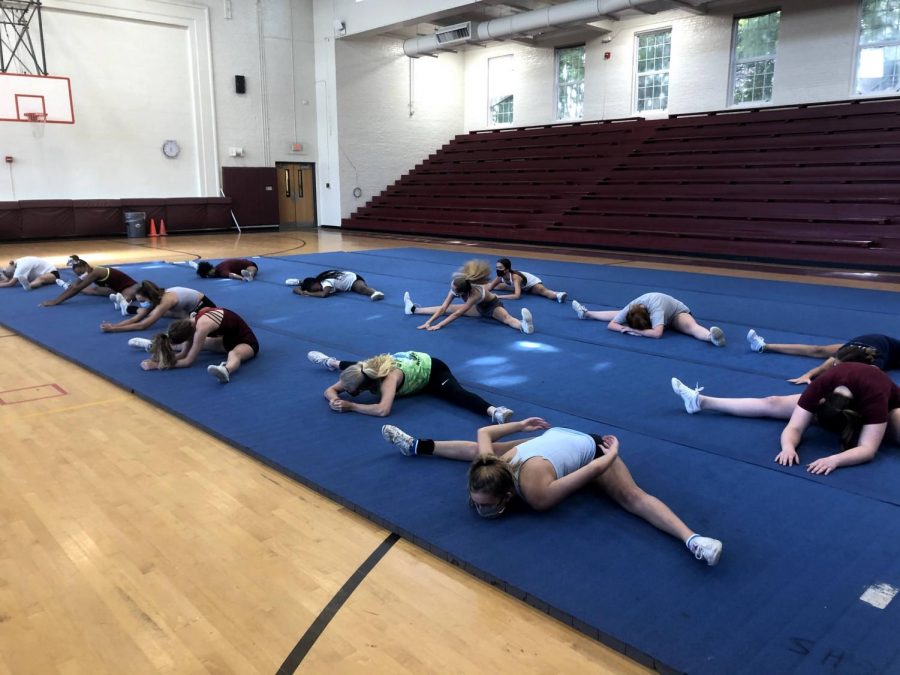 Grady+Cheer+stretches+with+masks+on+before+their+practice+begins.