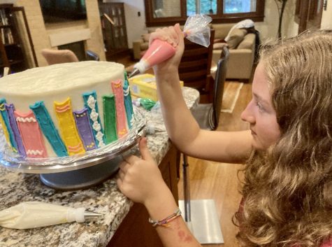 Freshman Virginia Laster sold her first cake on Mar. 20. Since then, she has sold approximately 20 more. Laster fully concentrates on every detail as she frosts the book decorations.