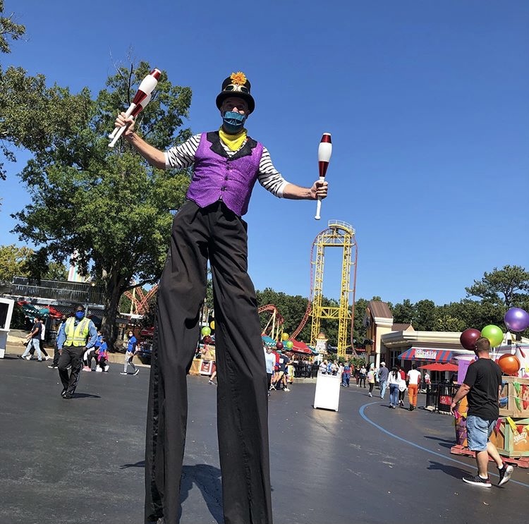 Six flags worker, having fun while displaying safety measures. Everyone is required to wear mask.