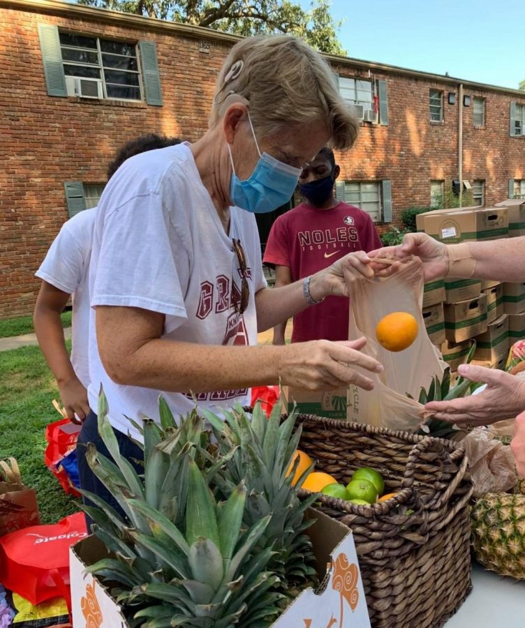 Dr. Betsy Bockman volunteers with Grady Cares at one of their food distribution sites. Grady Cares is one of the many organizations within the Grady cluster dedicated to helping the community.