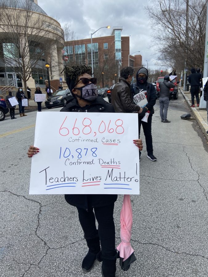 Protester+holds+up+a+sign+displaying+the+amount+of+confirmed+cases+and+confirmed+deaths+in+Georgia.+Teachers+and+staff+protested+at+the+Atlanta+Public+Schools+district+office+in+downtown+Atlanta+for+the+2020-2021+school+year+to+remain+virtual%2C+unless+COVID+cases+go+down.