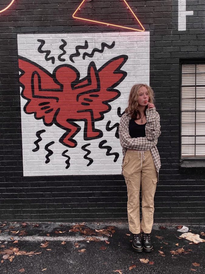 Carter poses in front of a small mural in Atlanta.