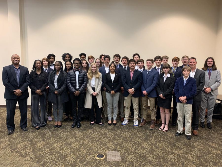 The+DECA+team+smiles+for+a+picture+at+the+2019+regional+competition.+