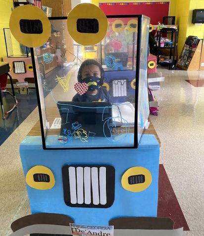 DeAndre Mahone Jr., a kindergartener at Hope Hill Elementary school, works at his classroom desk. His teacher decorated her students desk shields like cars.