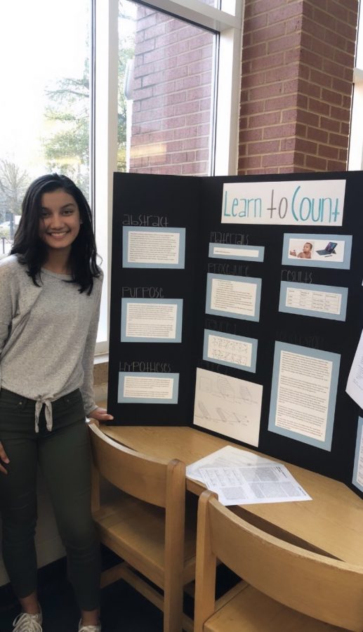 Sophomore+Sofia+Vempala+poses+with+her+project+at+last+years+Grady+science+fair.+Vempala+received+best+design+and+second+best+overall+at+the+school+fair.