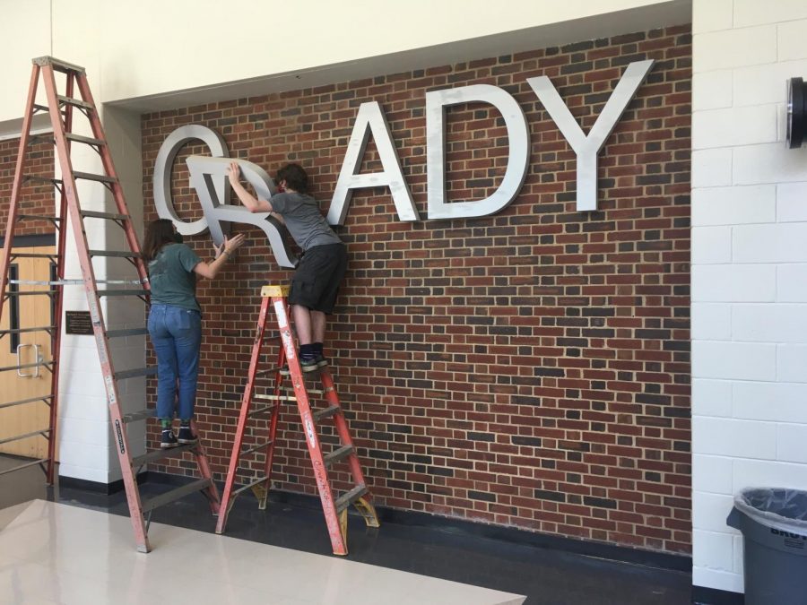 Student volunteers disassemble the Grady sign in the theatre lobby. The rebranding advisory team has finished conducting community listening sessions and has now opened up submissions for logo design. The first round of submissions should be submitted to John Brandhorst at jbrandhorst@atlanta.k12.ga.us by March 14.