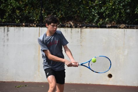 Sophomore Ethan Bass practices with head tennis coach Val Taylor on March 30. Bass also practices outside of school with the Universal Tennis Academy and competes nationally through the United States Tennis Association.