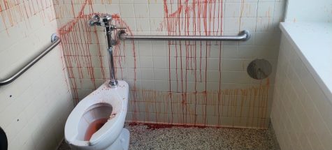 A student vandalized the boys C300 bathroom with red and orange pigment. Custodians were unable to remove the pigment from the flooring.