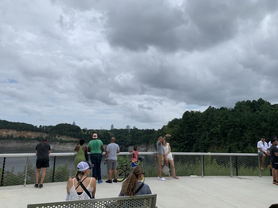 Visitors of the park look out over the Bellwood Quarry with a view of the Atlanta Skyline.