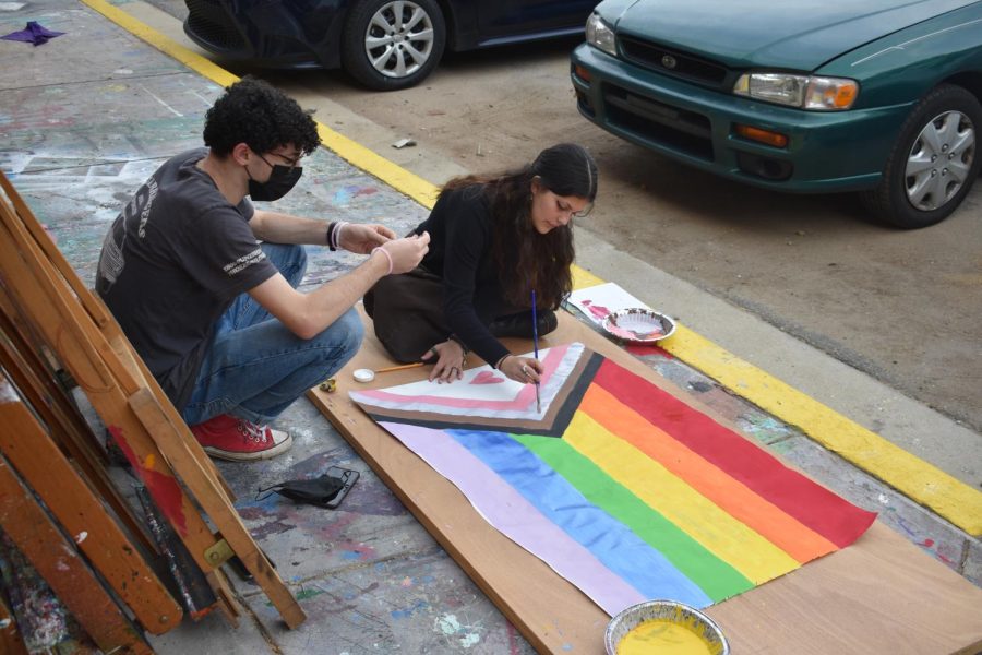 Seniors Brody Weiss (left) and Georgia Rice paint a Pride flag for the Gender-Sexuality Alliance Pride event. The event will take place on Oct. 29, from 5:30-8 p.m. 