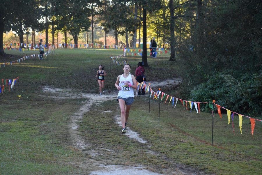 Junior and individual region champion Jamie Marlowe finishes her first lap of the two-lap course, putting a gap between her and a runner from North Springs.