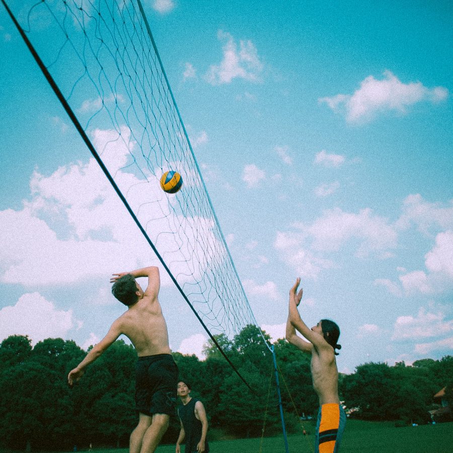 Senior Brandon Lopez prepares to try to block a jumping Aiden Scaranos spike at a meeting for volleyball club in Piedmont Park.
