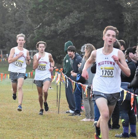 Midtown’s top three finishers sprint down the final stretch of the region course at
Clinton Nature Preserve. The boys won the meet and swept top three in the race. Left to right: Seniors
William Palmer (16:39, 2nd place), Everett Schroeder (16:40, 3rd) and Marcus Johnson (1st, 16:37)