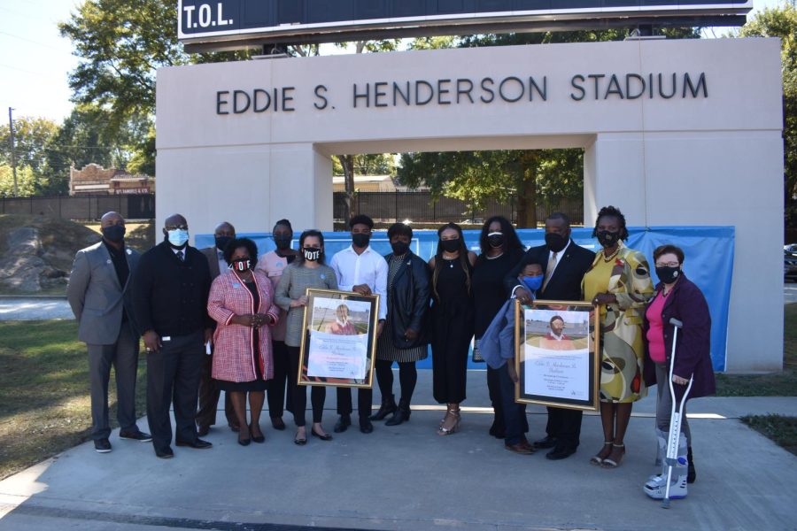 Speakers, including family members of Eddie S. Henderson, Superintendent Dr. Lisa Herring and  Atlanta Board of Education members posed in front of the new sign, honoring him. 