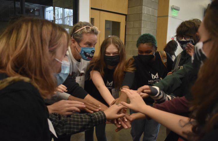 Students Malori Switzer, Addie Halloran, Ifama Frazier, Isabelle Perry and Aisling Mahony (from left to right) gather around John Brandhorst for a pre-competition pep-talk. "The competition required me as a teacher to become a coach, I had to connect with my students in a different way," Brandhorst said.