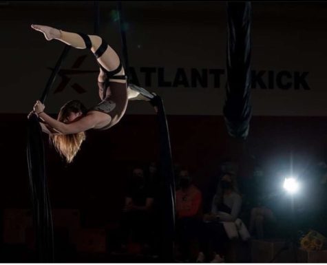Junior Leah Benator completes a corset split in her winter performance at Atlanta Kick.
