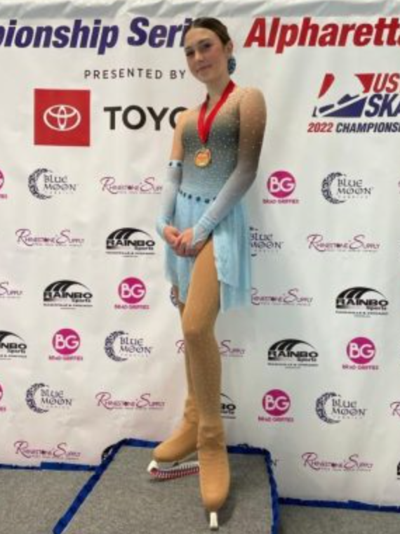 Leia Beinenson stands on the podium after placing second at the East Coast regionals in November of 2021. 