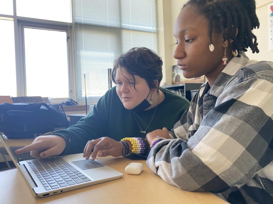 Junior Skylar Sweet (left) and sophomore Gryffin Thomas (right) work on a digital spread for "The Unmasking."
