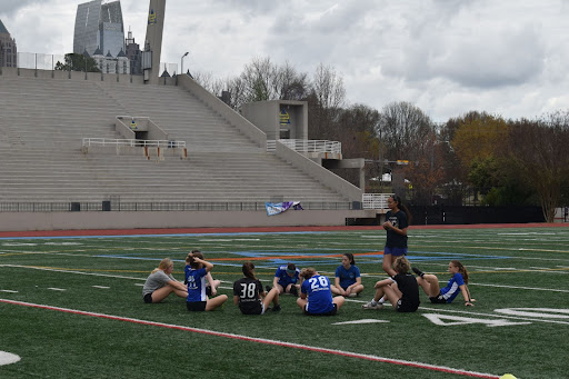 First year head coach Phoebe Mason talks to the girls JV soccer team during a practice. 