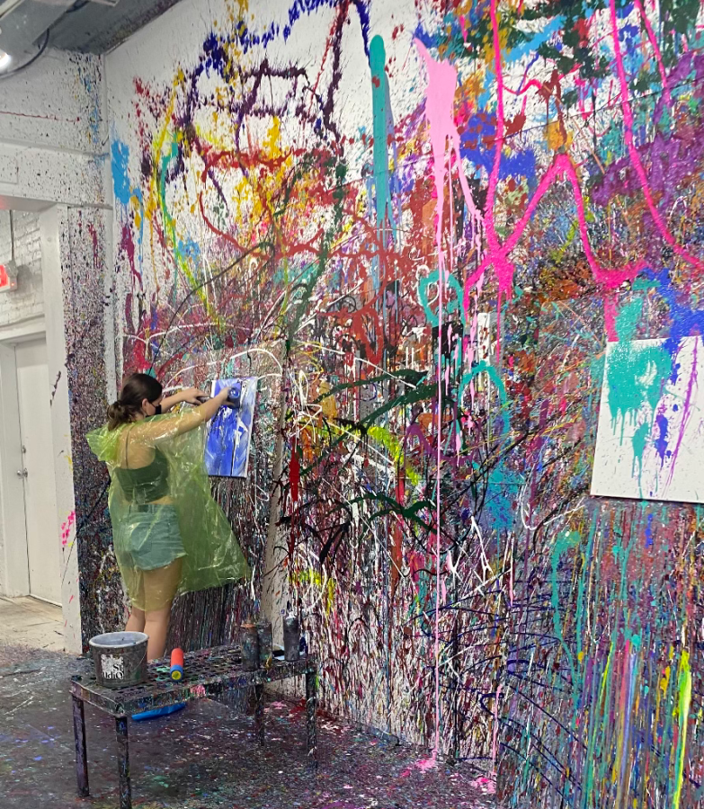 Sophomore Delia Schroeder paints without limitation at Splatter Studio.