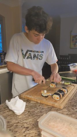Sophomore Sawyer Miyake prepares sushi for the upcoming lunch period. Miyake, whose family is originally from Japan and lived in Hawaii before it was claimed by the United States, enjoys connecting to his heritage through food.