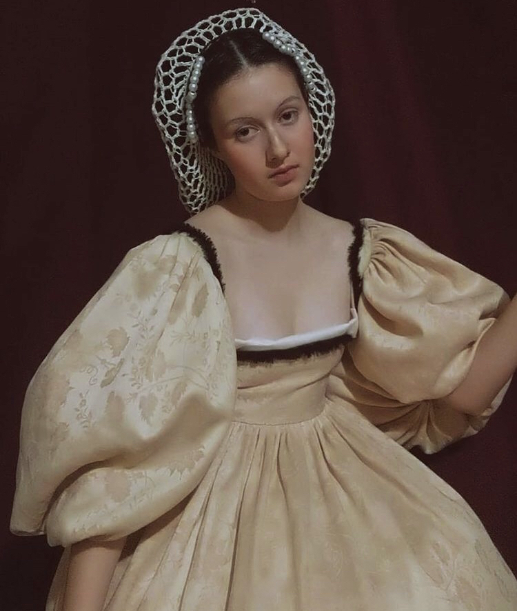 Junior Annamaria Holston poses for a photo in her handmade Victorian-era dress.