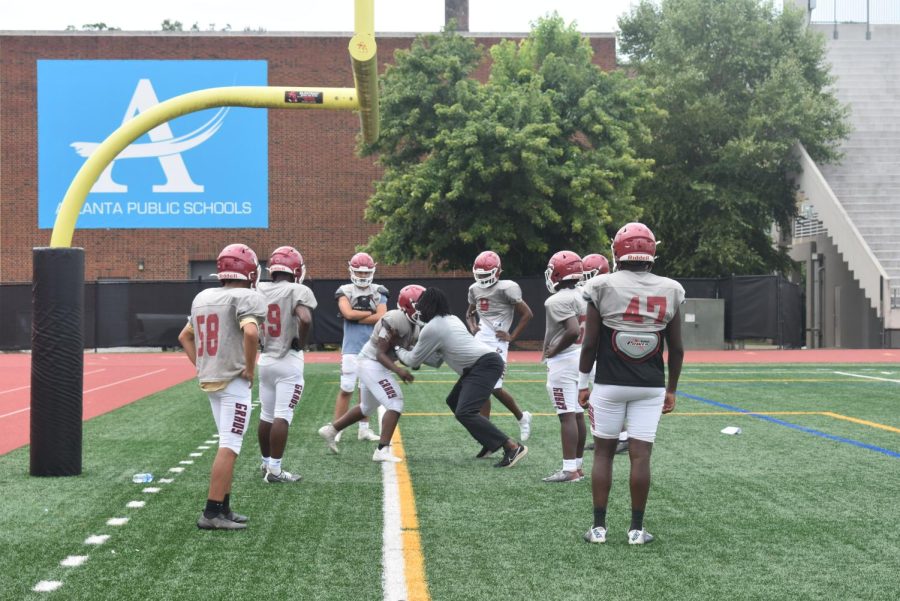 Coach Jackson helps the D-line with footwork and hand placement, preparing for the first home game of the season on Friday against KIPP Atlanta Collegiate.