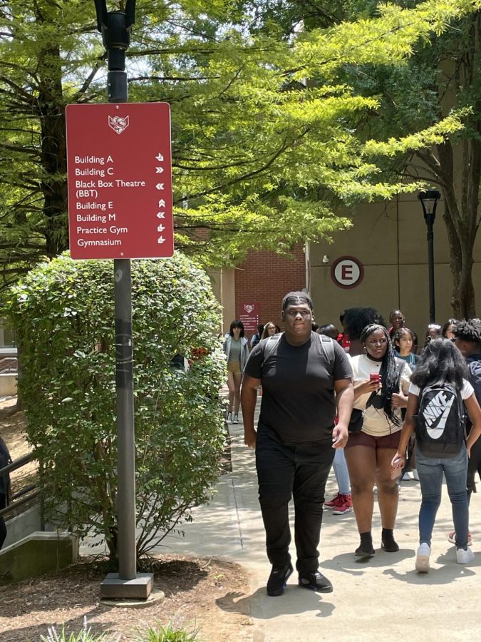 Students walk past the new signage around school. The signage project aims to make the campus easier to navigate for new students and visitors
