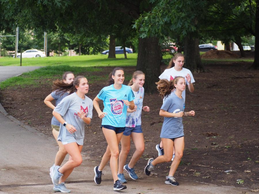 The girls cross country team heads out for a three mile loop around Piedmont Park.