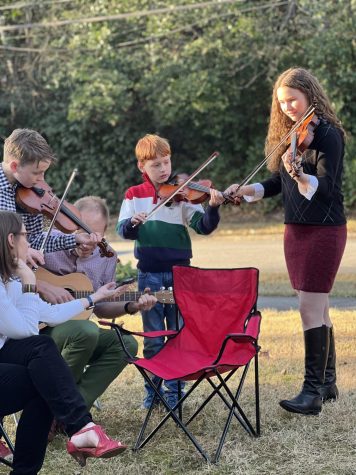 Siblings Joseph, Linden and sophomore Marian Waller perform together with their father, Michael Waller. Over COVID quarantine, they put on mini porch concerts for their neighbors. 