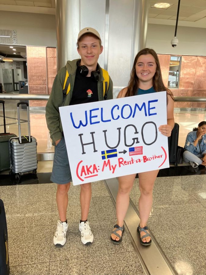 Junior Caitlin Stanley (right) welcomes Hugo Adolfsson (left) to Atlanta with a sign after three connecting flights from Gothenburg, Sweden to Atlanta.