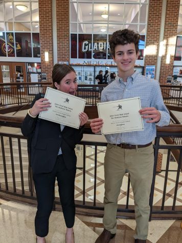 Debate competitors junior Fiona Bray and freshman Harrison James showcase their awards after participating in their first in-person competition.