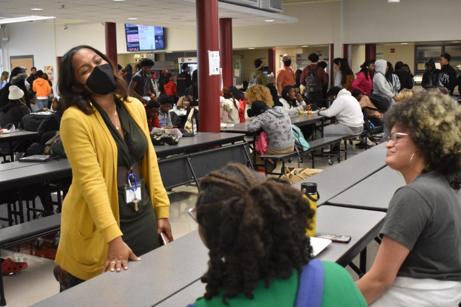Former Assistant Principal Tekeshia Hollis began work as principal for Howard Middle School. Before leaving, she enjoyed walking around during lunch periods to talk to students in the cafeteria. Students Ari Dumas and Selah Ramos, seen in this picture, are laughing with Hollis.