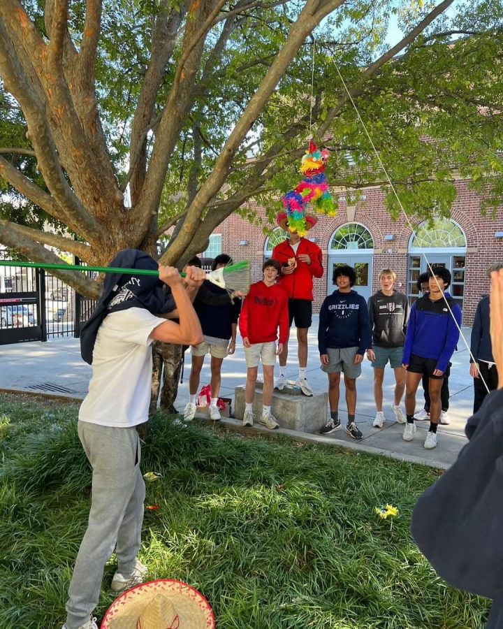 Spanish club members watch as a piñata is hit during their first meeting. The club hopes to expose students to the traditions of Hispanic culture.