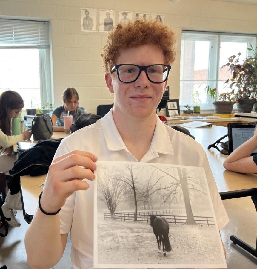 Senior+Ethan+Polk+showing+off+his+photo+titled%2C+National+Champion%2C+which+was+the+only+piece+of+Midtown+Art+accepted+into+the+Atlanta+Dogwood+Festival+student+art+gallery.
