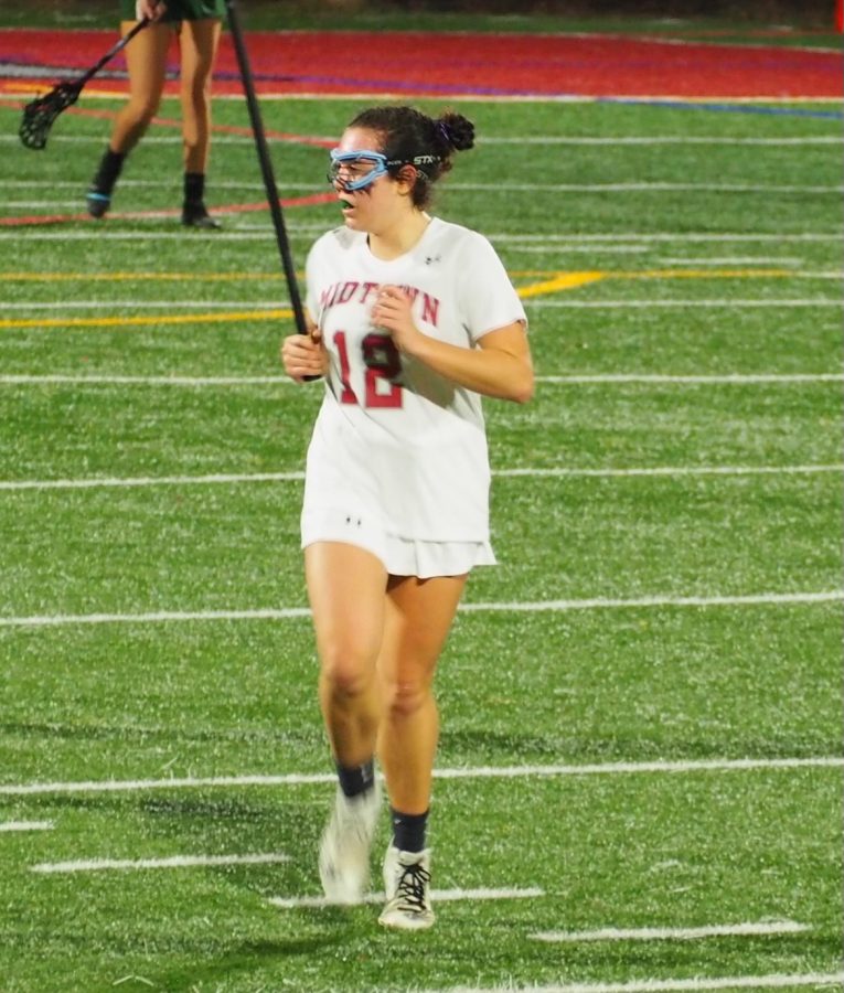 Junior+midfielder+Shea+Edward+charges+down+the+field+creating+an+offensive+play+in+her+during+her+junior+year+season.