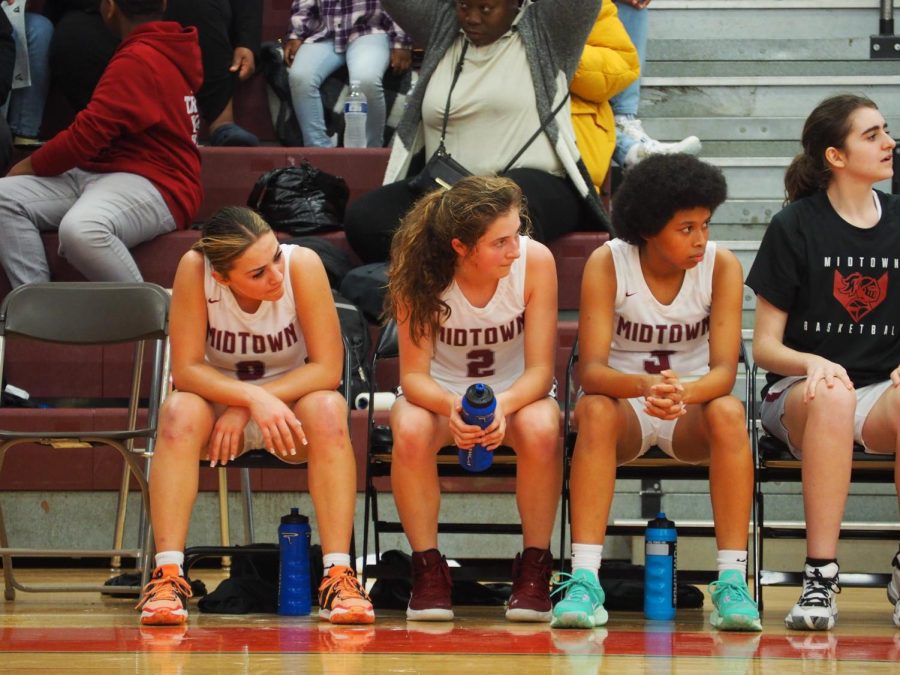 Alexia+Davis%2C+Cate+Barton%2C+and+Devon+Bockman+sits+on+the+bench%2C+waiting+to+contribute+to+the+game.+
