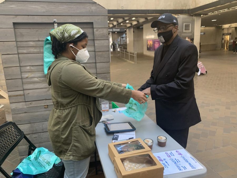 Daijah Suggs, the Five Points MARTA Market manager, provides a bag for a customer in the checkout line of the market. The transfer point between all rail lines, Five Points is run by a variety of managing and community partners.