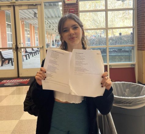 Bolster holds The Albatross by Kate Bass and I am Offering This Poem by Jimmy Santiago Baca, two poems she recited for the regional Poetry Out Loud competition. 