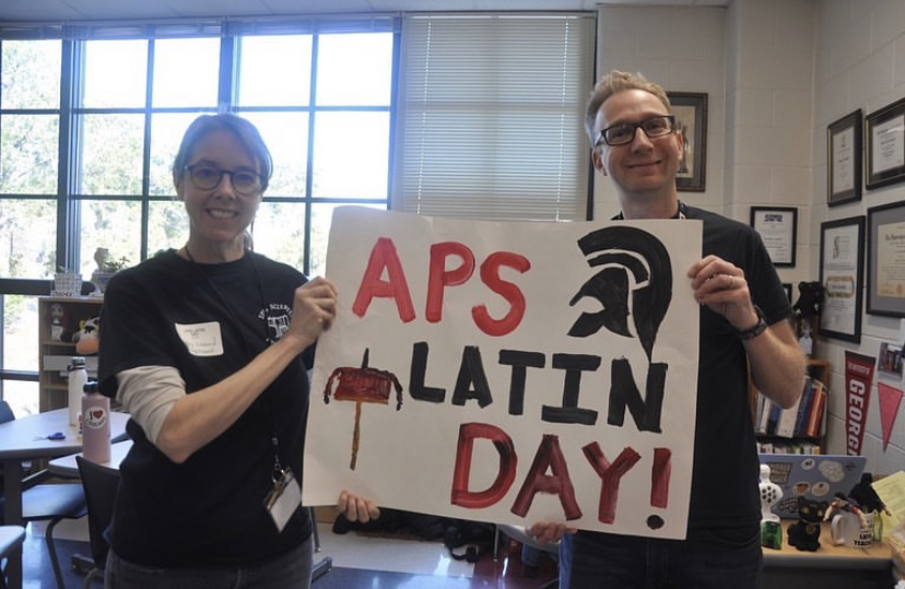 Leonard (left) and Allen (right) hold a sign for APS Latin Day. A day for APS students to come out and do Latin-based activities at Midtown.