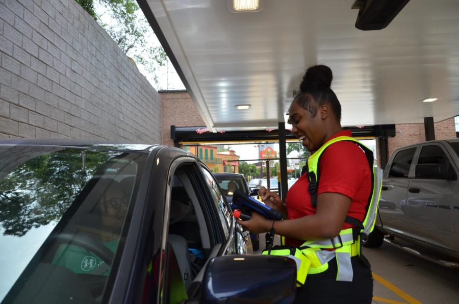 With a welcoming smile, Chick-fil-A prides itself in serving with pleasure. Employee and local student Johnnita Wickerson depicted above has gone through training to efficiently and enthusiastically serve customers. 