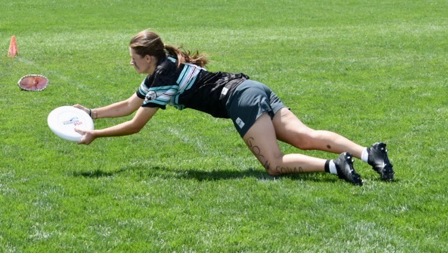 Sophomore Natalie Johnson lunges across the sideline to complete a catch.