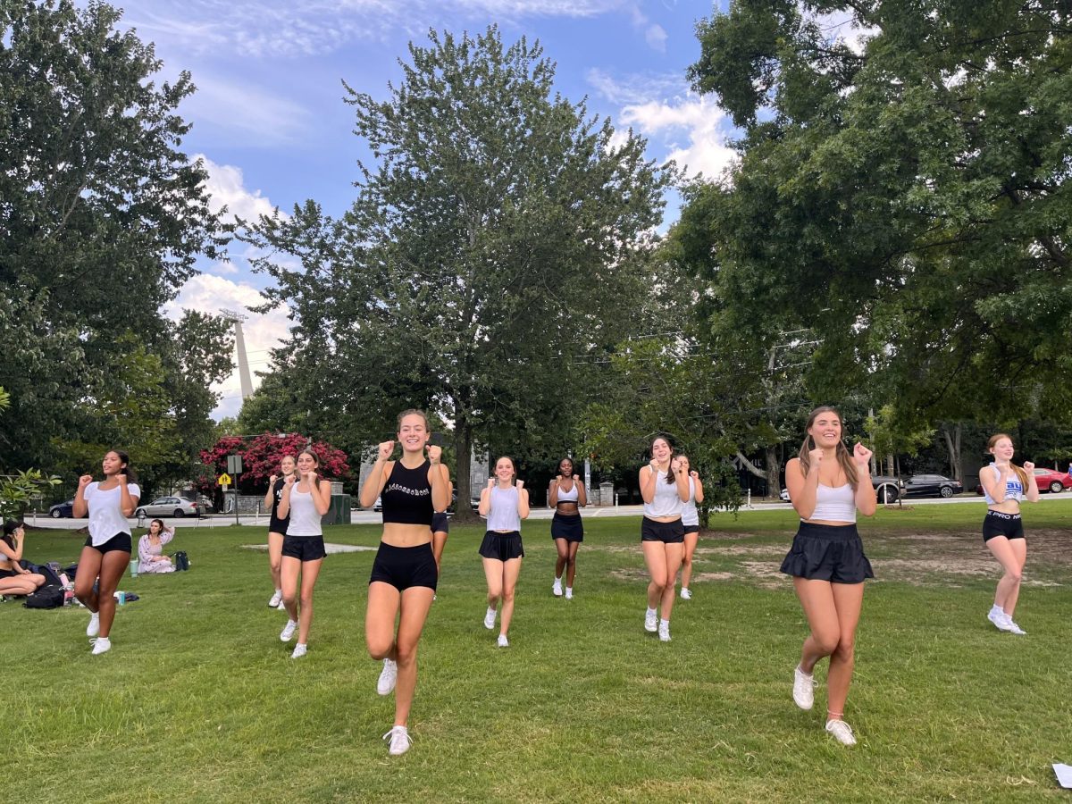 Midtown cheerleading team practices in Piedmont Park following a bomb threat call to the school administration, which canceled all extracurricular activities on campus.