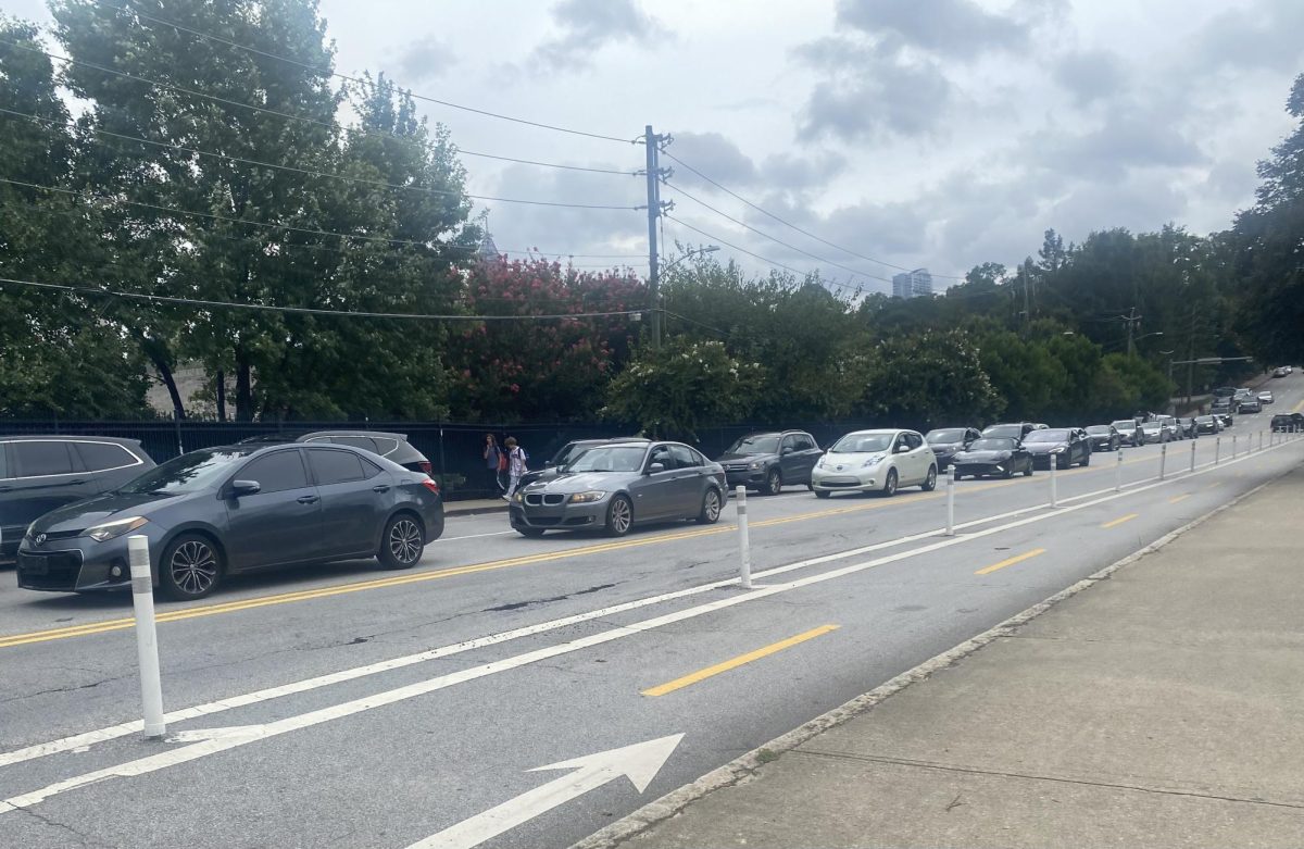 Two+lines+of+cars+coming+out+of+the+Midtown+parking+lot+and+into+10th+Street+soon+after+school+ended.+This+bumper-to-bumper+traffic+is+common+at+this+time%2C+causing+many+problems+as+the+cars+run+idle.